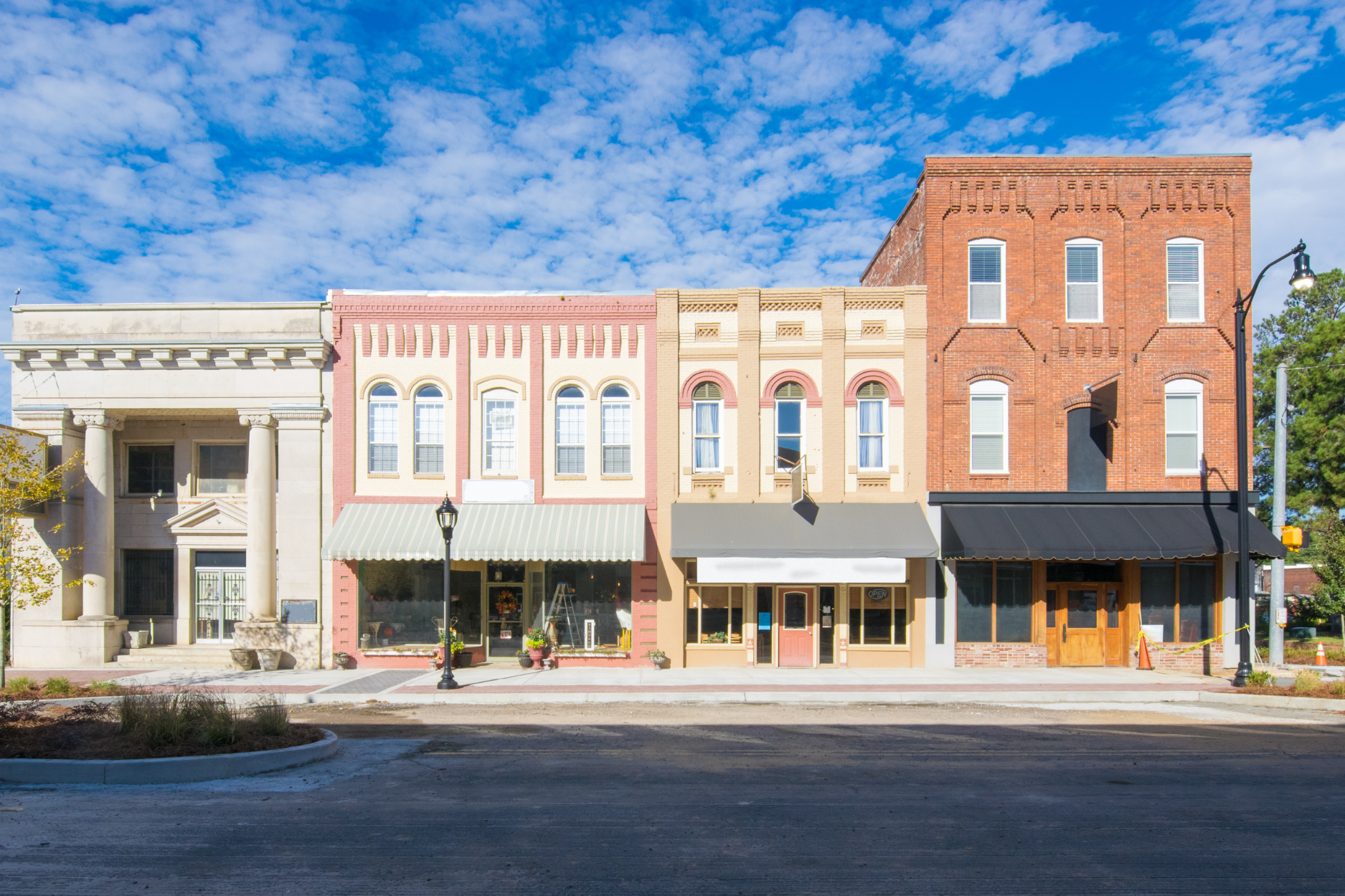 A serene street scene featuring a few buildings, highlighting the charm of the neighborhood.